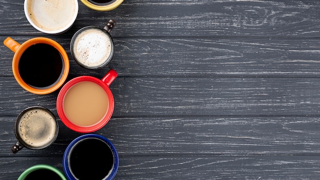 Coffee cups on wooden table with copy space