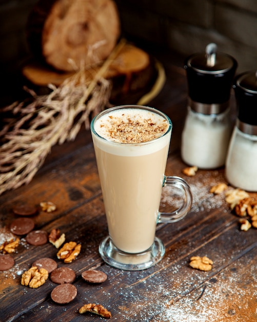 Coffee drink topped with crushed cookie and walnuts