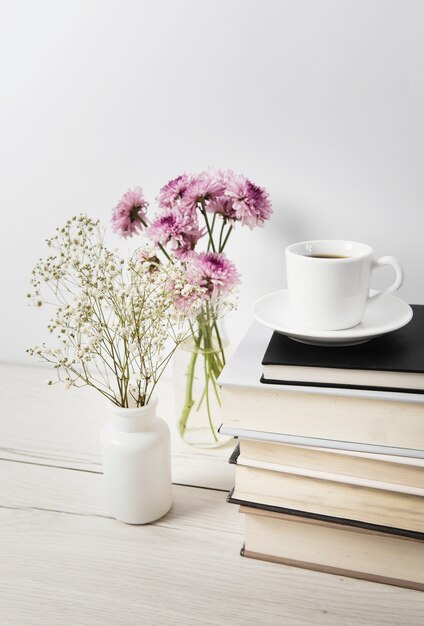 Coffee and flowers on plain background