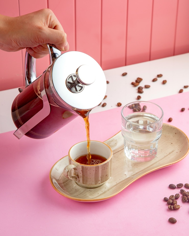 Free Photo coffee in french press with glass of water and coffee beans on table