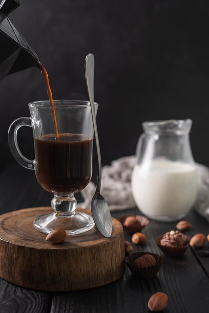 Coffee in glass with milk and truffles