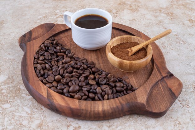 Coffee in ground, brewed and bean forms on a tray 