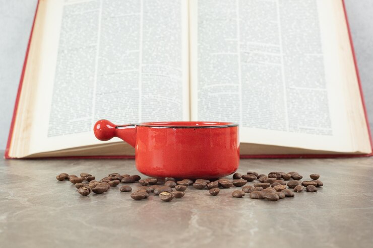 Free Photo coffee on marble surface with coffee beans and book