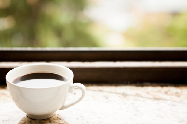 Coffee mug on a window sill. Morning coffee