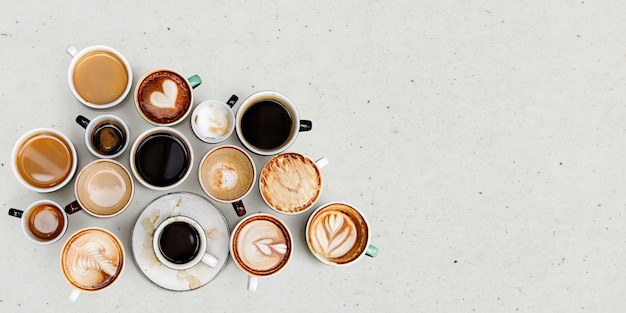 Coffee mugs on a light beige textured wallpaper