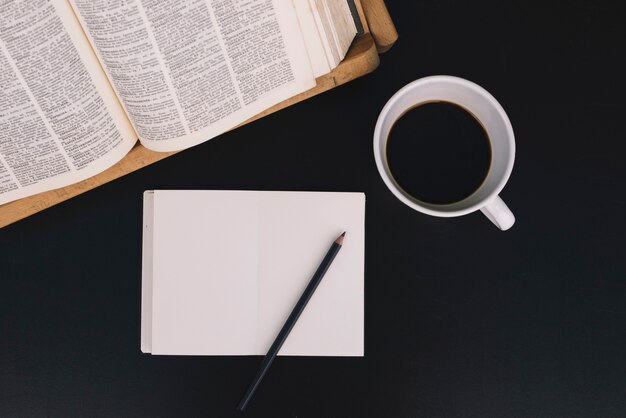 Coffee and notebook near book