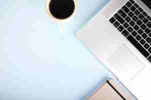 Free photo coffee and notebook near laptop