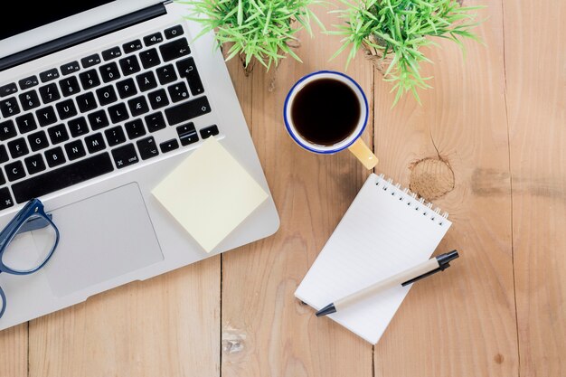 Coffee and opened notebook near laptop