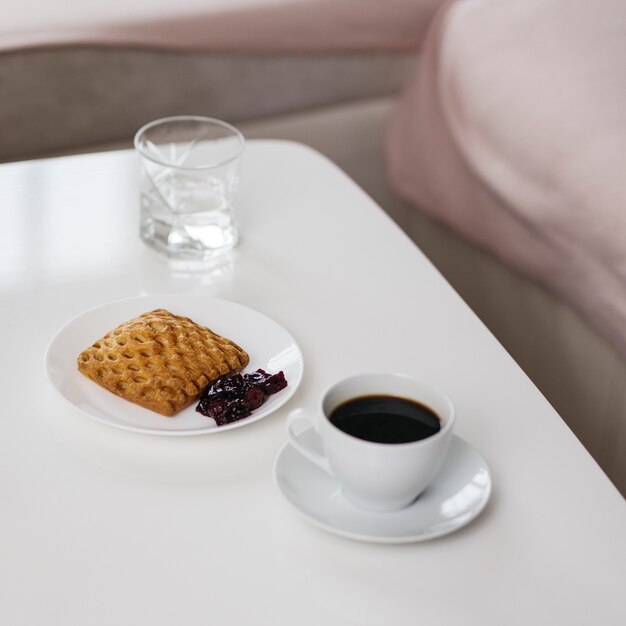 Coffee and pastry on table