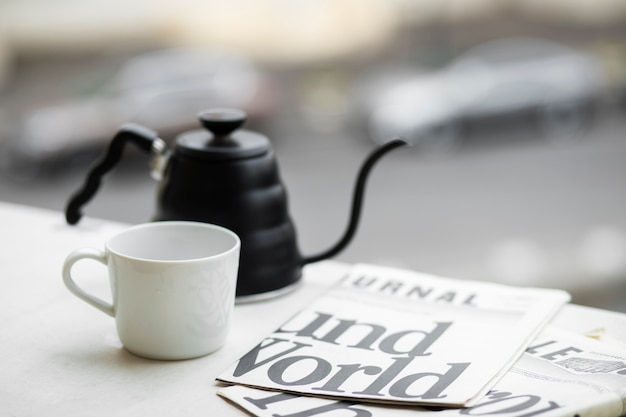 Free photo coffee pot and cup arrangement