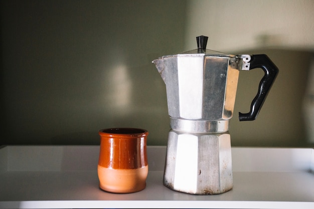 Free photo coffee pot and cup