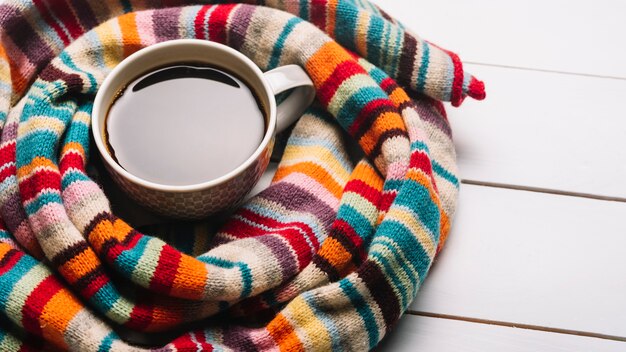 Coffee and scarf on table