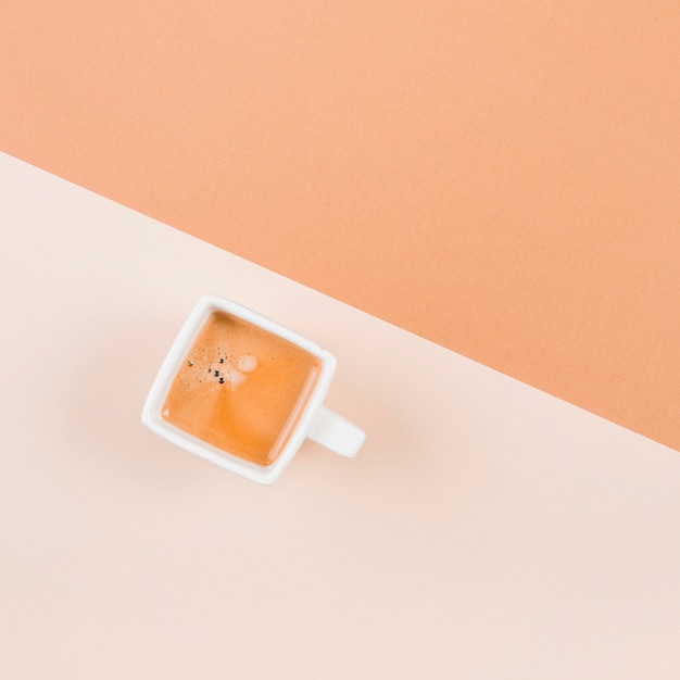 Coffee in white cup on dual background