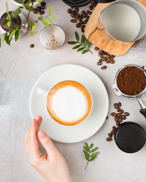 Coffee with latte art in a white ceramic cup on a table