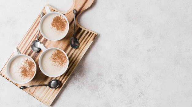 Coffee with milk on wooden board with copy space