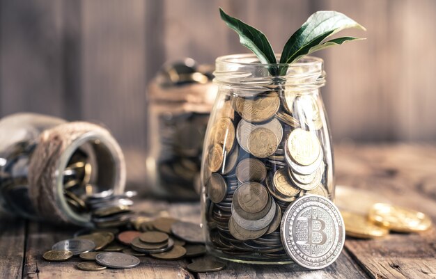 coin Bitcoin and a jar with coins