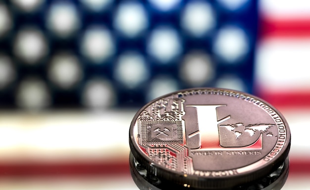 coin of litecoin on an American flag background, the concept of virtual money, closeup.