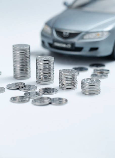 Free photo coin stacks in front of car