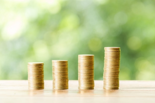 Coin on wooden table on blurred nature