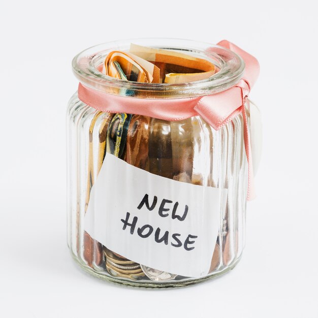 Coins And Euro Notes In The Glass Jar Decorated With Pink Ribbon