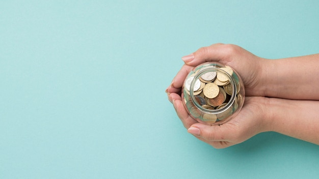 Coins in glass jar with copy space