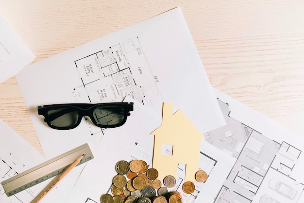 Coins and house with glasses