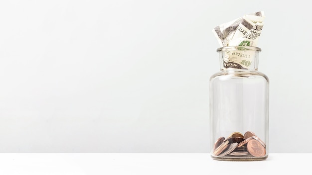 Coins inside of a bottle with copy space