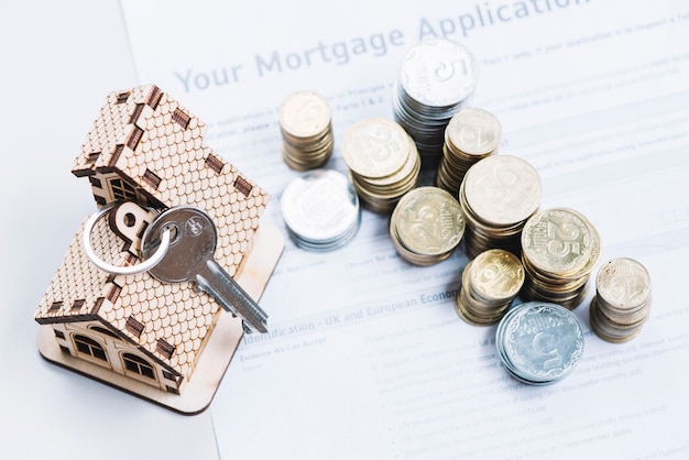 Coins and key on sheet of mortgage application