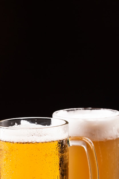 Cold beer mugs with foam