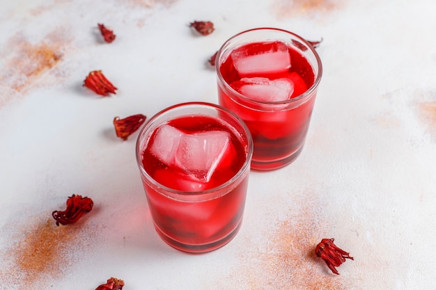 Free photo cold brew hibiscus tea with ice and basil leaves.