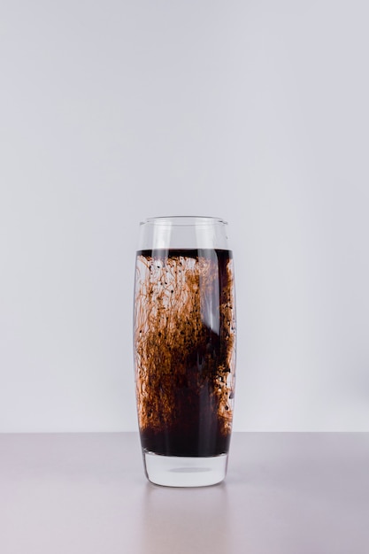 Cold dark cocktail on white