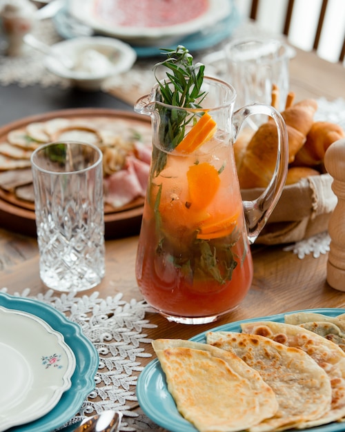 Cold lemonade with fruits and herbs