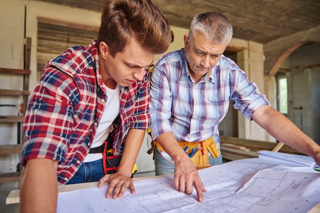 Collaboration of two carpenters in building