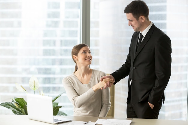 Colleagues congratulating each other with success