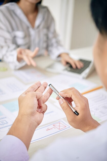 Colleagues counting with fingers while working