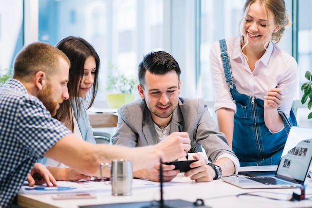 Colleagues discussing plans on smartphone