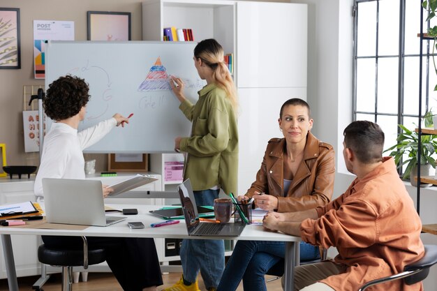 Colleagues discussing at work side view