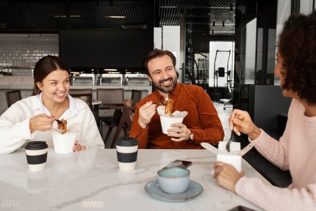 Colleagues eating noodles during break