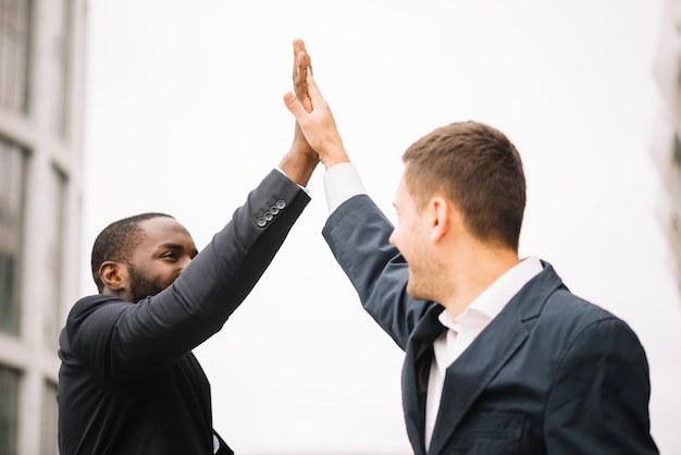 Free photo colleagues giving high five