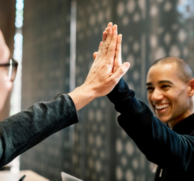 Free photo colleagues giving a high five