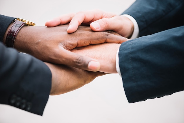 Colleagues holding hands together