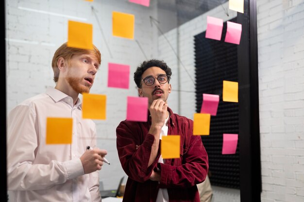 Colleagues looking at post its medium shot