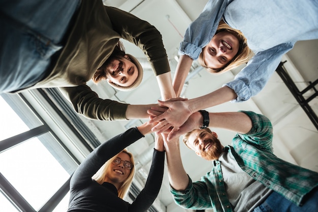 Colleagues in office holding hands of each other