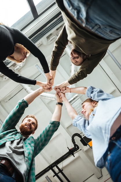 Colleagues in office holding hands of each other