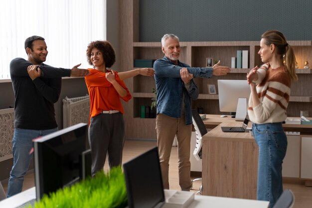 Colleagues at the office stretching during a work day