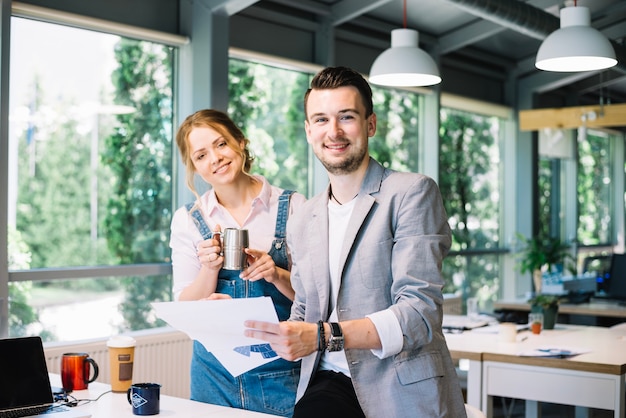 Colleagues posing with document in office