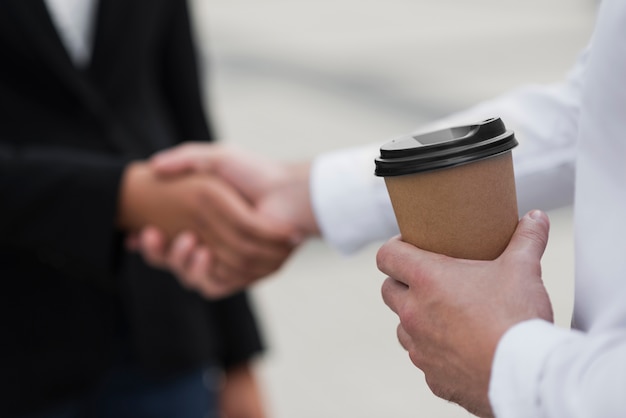 Colleagues shaking hands close up