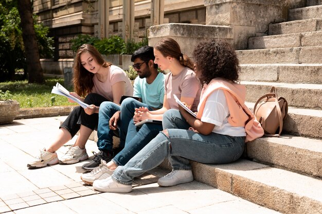 Colleagues studying together in front of their college before an exam