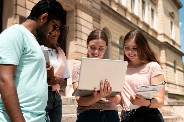 Colleagues studying together in front of their college