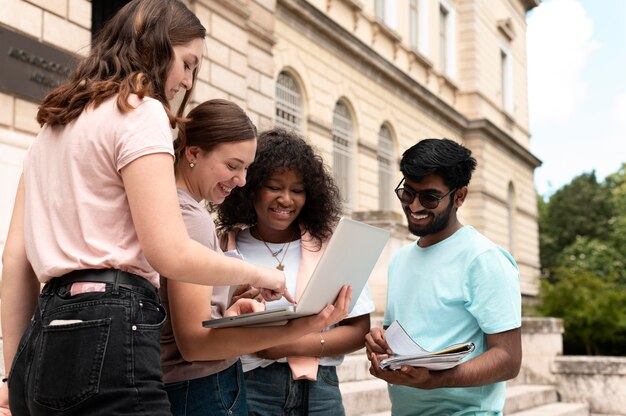 Colleagues studying together in front of their college